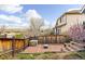 Fenced backyard featuring a brick patio with a fire pit and partial views of the surrounding landscape at 2590 S Independence St, Lakewood, CO 80227