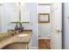 Bathroom with granite countertop vanity, brushed nickel faucet, and a large mirror at 2590 S Independence St, Lakewood, CO 80227
