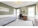 Bedroom with olive green walls, wainscotting, neutral carpet, and a writing desk at 2590 S Independence St, Lakewood, CO 80227