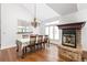 Dining room featuring a fireplace, wood floors, and a modern chandelier above the dining table at 2590 S Independence St, Lakewood, CO 80227