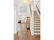 Bright, two story entryway with hardwood floors, staircase, and decorative furniture at 2590 S Independence St, Lakewood, CO 80227