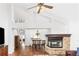 Bright living room with high ceilings flowing into a dining area featuring a fireplace at 2590 S Independence St, Lakewood, CO 80227
