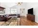 Inviting living room featuring high ceilings, large windows, hardwood floors, and a leather sectional at 2590 S Independence St, Lakewood, CO 80227
