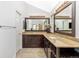 Double sink bathroom with granite counters, two mirrors, and modern vanity lighting at 2590 S Independence St, Lakewood, CO 80227