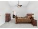 Spacious main bedroom features a ceiling fan, a sleigh bed, and leads to the main bathroom at 2590 S Independence St, Lakewood, CO 80227