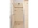 Shower stall features tile surround, built-in shelving, and a glass door at 2590 S Independence St, Lakewood, CO 80227