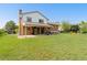 Large backyard showcasing green grass and a covered patio at 3907 E 133Rd Ct, Thornton, CO 80241