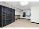 The basement has carpet flooring and wood paneling around the room at 3907 E 133Rd Ct, Thornton, CO 80241