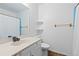 Cozy bathroom featuring a vanity, toilet, updated fixtures, and a shower with a curtain, offering a functional space at 3907 E 133Rd Ct, Thornton, CO 80241