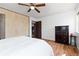 Bedroom with wood-look flooring, a queen bed, a large dresser, and a small table, offering a blend of functionality and comfort at 3907 E 133Rd Ct, Thornton, CO 80241