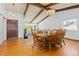 Inviting dining room with hardwood floors, wooden beams, large windows, and a spacious layout, perfect for gatherings at 3907 E 133Rd Ct, Thornton, CO 80241