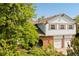 Two-story home featuring brick accents, shuttered windows, brick arches, and a two-car garage at 3907 E 133Rd Ct, Thornton, CO 80241