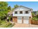 Charming two-story home with a brick facade, two-car garage, and beautifully landscaped front yard with colorful flowers at 3907 E 133Rd Ct, Thornton, CO 80241