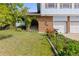Well-maintained home exterior with a brick facade, arched entryway, landscaped garden beds, and a two-car garage at 3907 E 133Rd Ct, Thornton, CO 80241