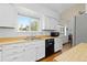 Efficient kitchen with white cabinets, wood countertops, black appliances, and a bright window, perfect for cooking at 3907 E 133Rd Ct, Thornton, CO 80241