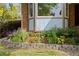 Close-up of vibrant flower beds, brick accenting, and bay windows adding charm to the home's exterior at 3907 E 133Rd Ct, Thornton, CO 80241