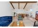 Spacious living room with exposed beams, plush seating, and an open floor plan, creating a welcoming atmosphere at 3907 E 133Rd Ct, Thornton, CO 80241