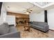 Cozy living room featuring a brick fireplace, ceiling fan, and comfortable couches at 3907 E 133Rd Ct, Thornton, CO 80241