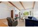 Cozy living room with comfortable seating, a large bay window, and an open layout leading to the dining area at 3907 E 133Rd Ct, Thornton, CO 80241