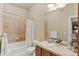 Bathroom with a bathtub, tile accents, and a wooden vanity at 10111 Inverness Main St # 312, Englewood, CO 80112