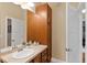 Bathroom with a tall vanity, tile counter, and view into the hall at 10111 Inverness Main St # 312, Englewood, CO 80112