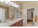 Bathroom featuring double sinks, and a walk-in shower, designed with a clean and modern aesthetic at 10111 Inverness Main St # 312, Englewood, CO 80112