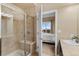 Well-lit bathroom featuring tiled walk-in shower and neutral decor at 10111 Inverness Main St # 312, Englewood, CO 80112
