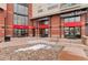 Close-up of the building entrance featuring modern design and clear signage for different businesses at 10111 Inverness Main St # 312, Englewood, CO 80112