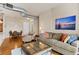 Relaxing living room open to dining area featuring comfortable seating and natural light at 10111 Inverness Main St # 312, Englewood, CO 80112