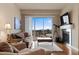 Comfortable living room with plush seating, fireplace, and sliding glass doors to a balcony at 10111 Inverness Main St # 312, Englewood, CO 80112