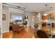 Open-concept living room featuring a fireplace, hardwood floors, and a balcony with neighborhood views at 10111 Inverness Main St # 312, Englewood, CO 80112