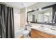 Well-lit bathroom featuring a vanity, a mirror, a toilet, and a shower with a neutral color palette at 8390 Coyote Dr, Castle Pines, CO 80108