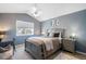 Neutral bedroom features a bed, a nightstand, and a desk near the window at 8390 Coyote Dr, Castle Pines, CO 80108