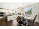Well-appointed kitchen featuring stainless steel appliances, white cabinetry, and an adjacent dining area at 8390 Coyote Dr, Castle Pines, CO 80108