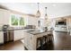 Bright kitchen featuring granite countertops, a large island, stainless steel appliances, and pendant lighting at 8390 Coyote Dr, Castle Pines, CO 80108