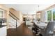 Open concept kitchen with modern appliances, island seating, and a view of the adjacent dining area at 8390 Coyote Dr, Castle Pines, CO 80108