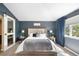 Comfortable main bedroom featuring a sliding door closet and stylish decor at 8390 Coyote Dr, Castle Pines, CO 80108