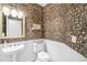 Charming powder room with decorative wallpaper, pedestal sink, and white wainscoting at 8390 Coyote Dr, Castle Pines, CO 80108