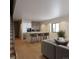 Inviting living area with hardwood floors, a comfortable couch, and a cozy kitchen in the background at 532 Lombardi Cir, Louisville, CO 80027
