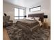 Elegant bedroom with ample natural light, featuring a plush bed and stylish furnishings at 532 Lombardi Cir, Louisville, CO 80027
