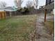 Spacious backyard with a wooden fence, offering privacy and room for outdoor activities at 220 Mckinley Dr, Bennett, CO 80102