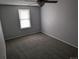 A carpeted empty bedroom with gray walls and natural light coming through the windows at 220 Mckinley Dr, Bennett, CO 80102