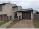 Front view of the house with a one-car attached garage and front door access at 220 Mckinley Dr, Bennett, CO 80102