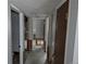 Hallway view showing doors and access to other rooms; showcasing the home's layout at 220 Mckinley Dr, Bennett, CO 80102