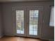 A set of french doors gives access to the backyard patio at 220 Mckinley Dr, Bennett, CO 80102