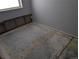 Room needing repair with exposed framework and plain gray walls under a window at 220 Mckinley Dr, Bennett, CO 80102
