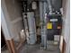 A view of the water heater and furnace installed next to each other in the utility room at 220 Mckinley Dr, Bennett, CO 80102
