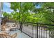 Inviting outdoor balcony with comfortable seating, a metal railing, and views of lush greenery at 9300 E Florida Ave # 1202, Denver, CO 80247