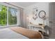 Charming bedroom with a desk, ample sunlight, and pleasant leafy green views at 9300 E Florida Ave # 1202, Denver, CO 80247