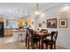 Bright dining area with a large window and a view into the open kitchen at 9300 E Florida Ave # 1202, Denver, CO 80247